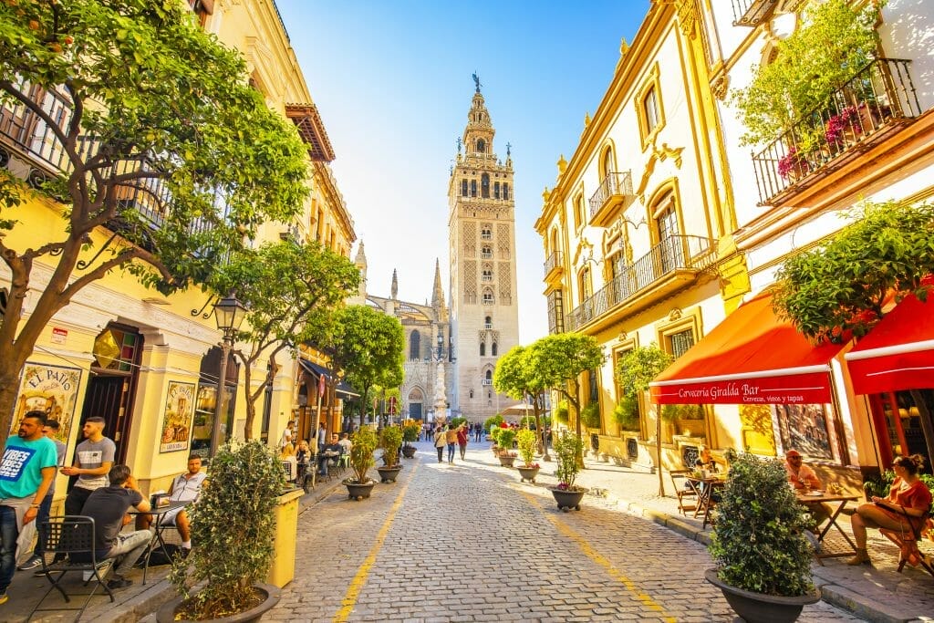 Sunny sevilla street and giralda tower, spain