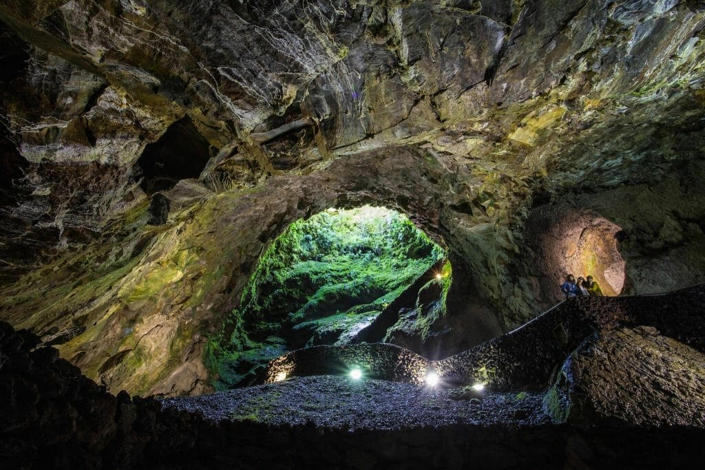 Inside the Algar do Carvão volcanic chimney, with moss-covered walls opening to daylight, Terceira Island, Azores, Portugal