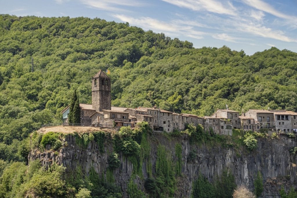 Castellfollit de la Roca on its basalt cliff in the Garrotxa, Catalonia, Spain