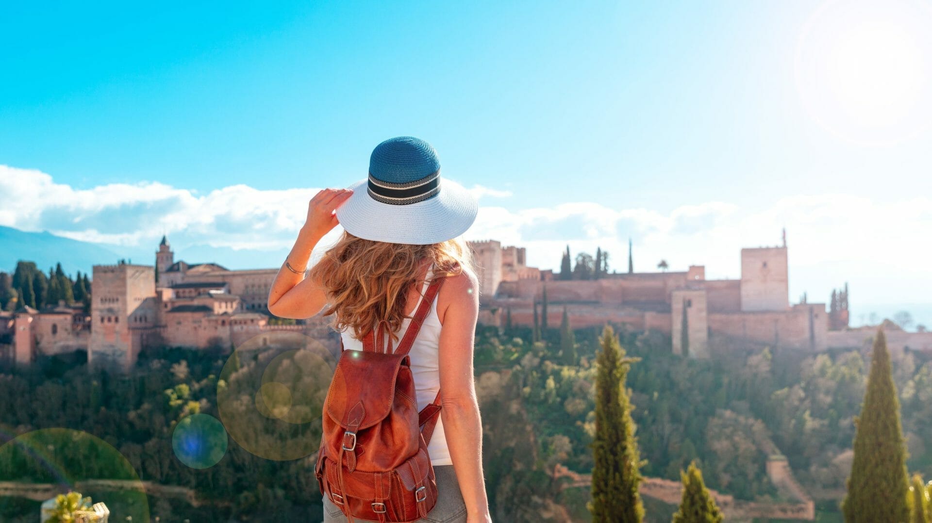 Woman Tourist Looking At spanish castle Alhambra Granada In Spain