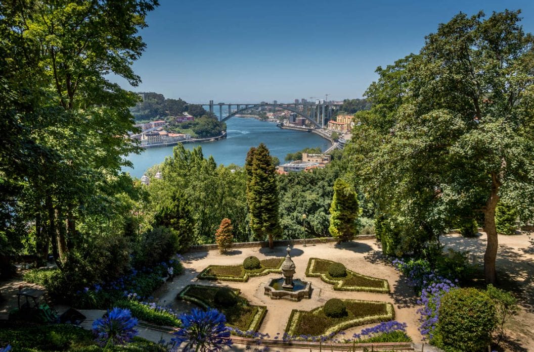Terraced gardens of the Palácio de Cristal with a fountain and agapanthus, overlooking the Douro River and the Arrábida Bridge, Porto, Portugal