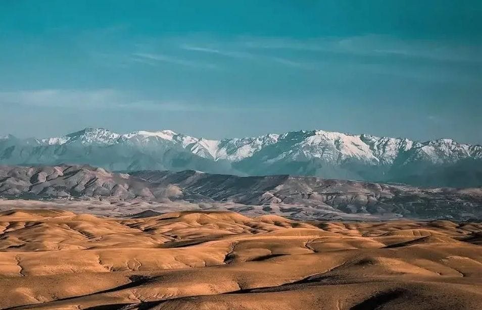 Agafay desert hills with the snowy High Atlas behind, near Marrakech