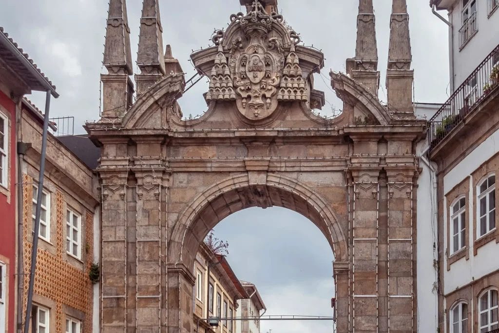 Baroque Arco da Porta Nova gateway with its carved coat of arms, opening into Braga's historic centre, Portugal