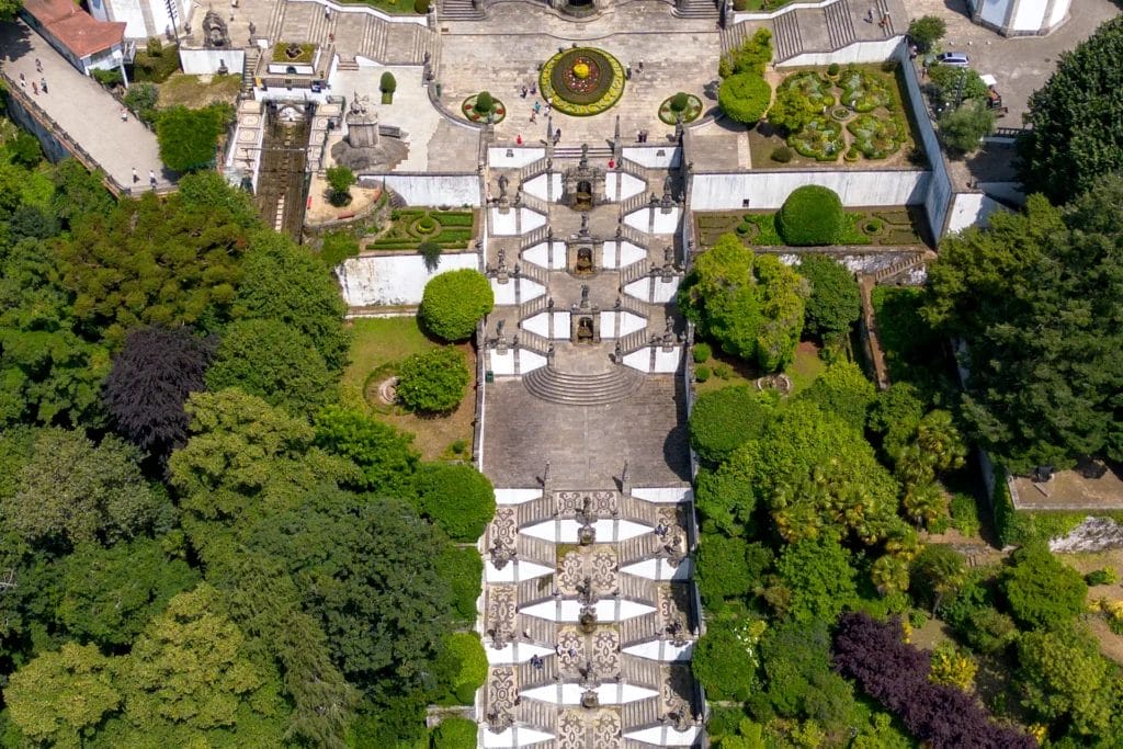 Aerial view of the zigzag Baroque stairway of Bom Jesus do Monte climbing through gardens above Braga, Portugal
