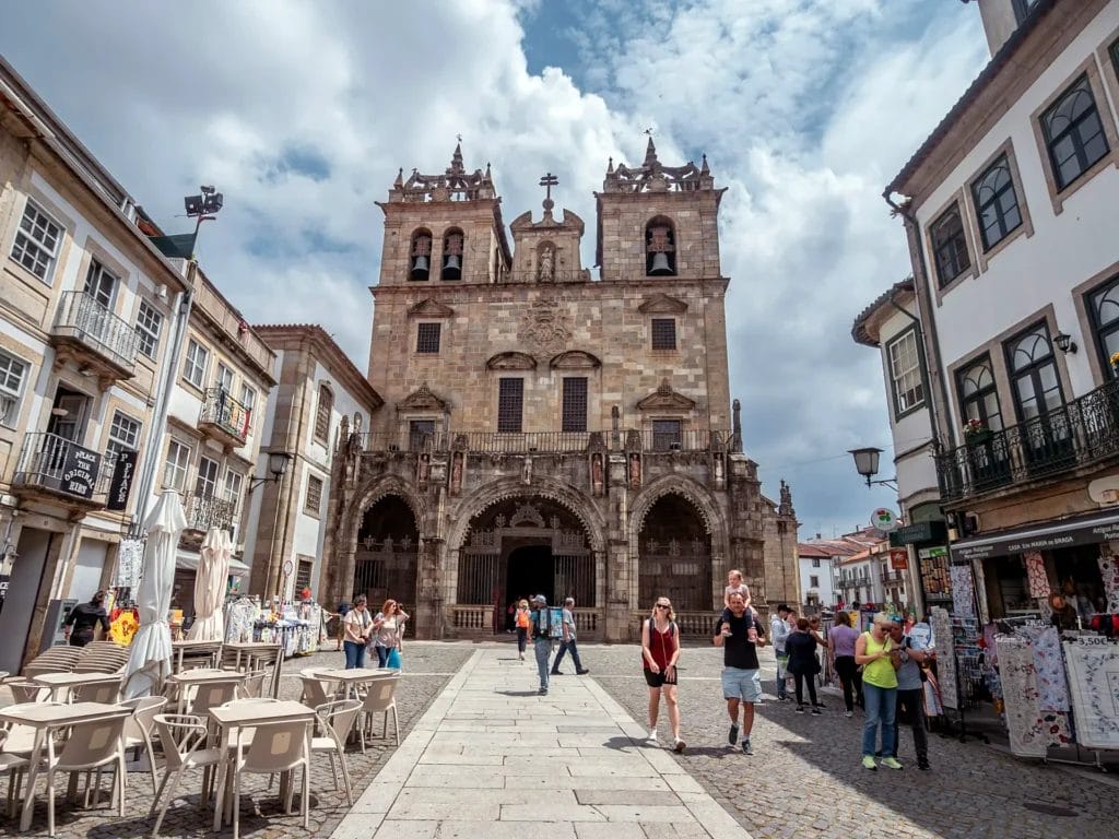 Street in Braga's old town leading to the twin-towered facade of Braga Cathedral, Portugal