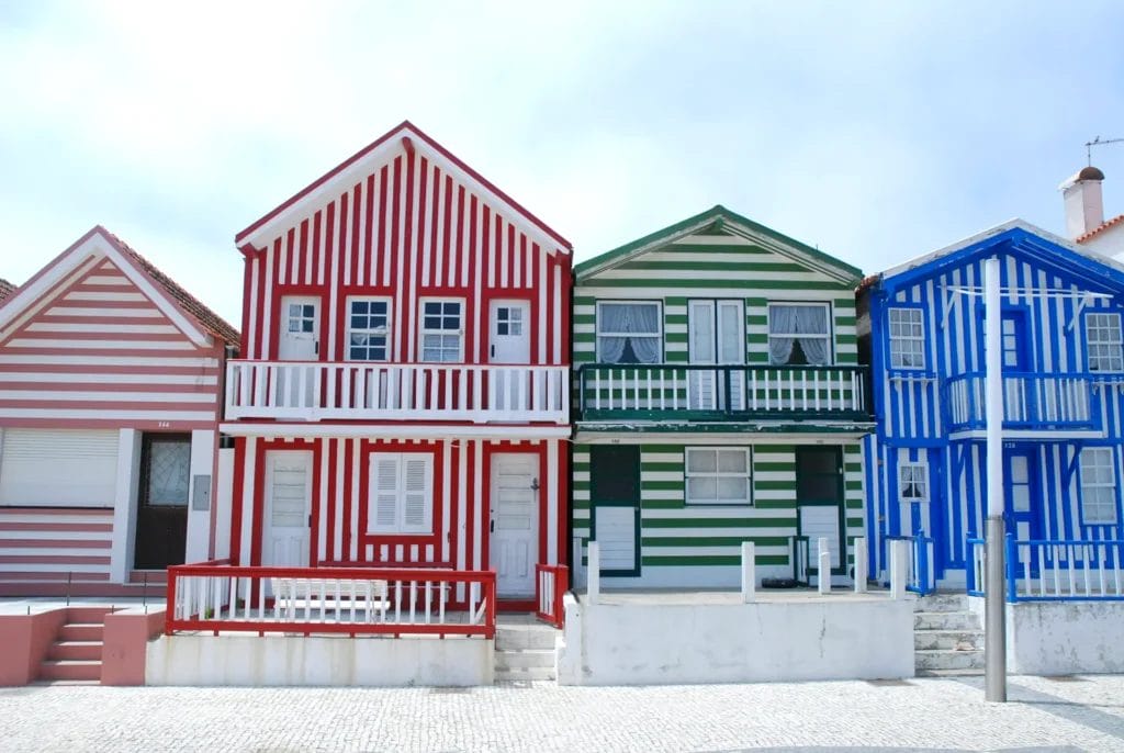Red, white, green and blue striped wooden houses of Costa Nova near Aveiro, Portugal